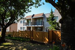 New Westminster apartment for rent - A modern two-story house with a balcony and a wooden fence.
