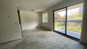 Surrey apartment for rent - A room with a sliding glass door leading to a balcony.