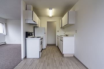 Surrey apartment for rent - A kitchen with white appliances and cabinets.