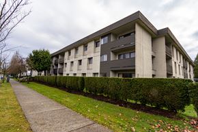 Surrey apartment for rent - A modern building with a grey facade and a concrete walkway in front.