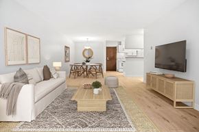 Coquitlam apartment for rent - A living room with a white couch, a wooden coffee table, and a television.