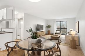 Coquitlam apartment for rent - A modern living room with a glass table and brown chairs.
