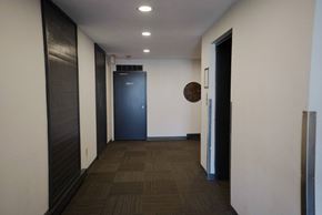 New Westminster apartment for rent - A long hallway with a blue door at the end.