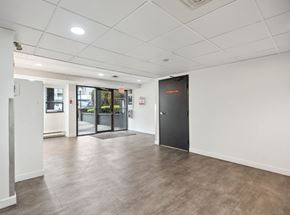 Richmond apartment for rent - A room with a black door and a brown floor.