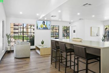 Phoenix apartment for rent - a living room with a bar and a tv on the wall