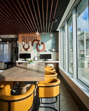 Chicago apartment for rent - A modern dining area with a wooden table and yellow chairs.