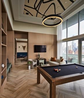 Chicago apartment for rent - A pool table is in the middle of a room with a TV and a couch.