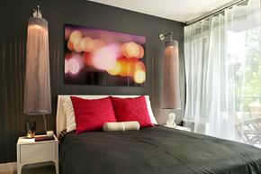 Richmond apartment for rent - A bedroom with a large bed and a painting on the wall.