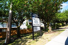 New Westminster apartment for rent - A sign for Fraser Property is displayed in front of a building.