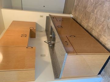 Surrey apartment for rent - A kitchen with wooden cabinets and a countertop.