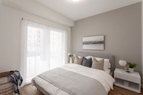 Port Coquitlam apartment for rent - a bedroom with a large bed and a window
