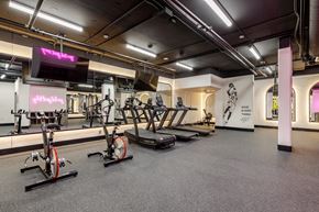 Vancouver apartment for rent - A gym with a row of stationary bikes and a television.