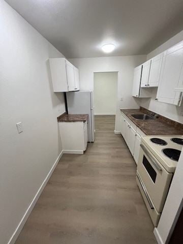 Surrey apartment for rent - A kitchen with white cabinets and a brown countertop.