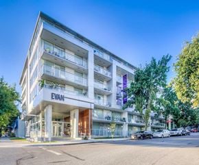 Vancouver apartment for rent - The image shows a modern apartment building named EVAN with cars parked in front and trees beside it.