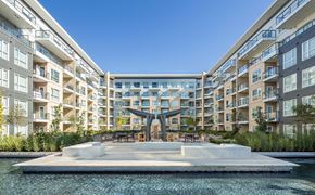 New Westminster apartment for rent - A modern building with a pool in front.