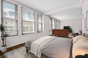 Los Angeles apartment for rent - A bedroom with a large bed and a potted plant.