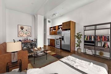 Los Angeles apartment for rent - A modern living room with a white sofa and a bookshelf filled with books.