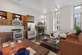 Los Angeles apartment for rent - A modern kitchen with a dining table set for two.