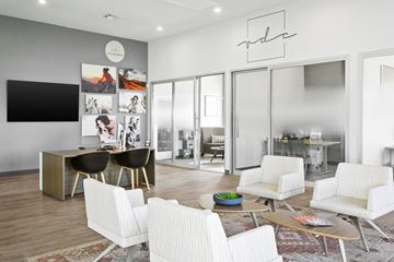 Phoenix apartment for rent - A modern living room with a white sofa set and a television.