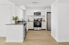 Mesa apartment for rent - A white kitchen with a black stove top oven.