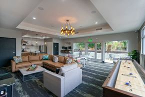 Mesa apartment for rent - A room with a shiny black floor and a pool table.