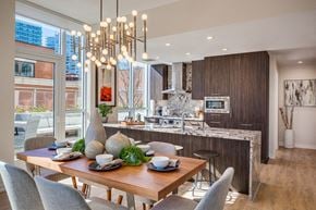 Chicago apartment for rent - A modern dining room with a wooden table set for a meal.
