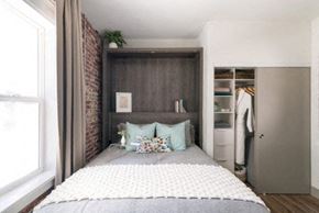 Los Angeles apartment for rent - A bedroom with a large bed and a brick wall.