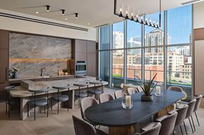Chicago apartment for rent - a dining room with a table and chairs and a kitchen with large windows