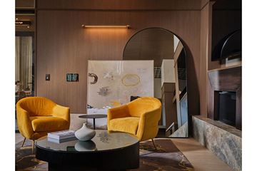 Chicago apartment for rent - A living room with a round table and two yellow chairs.