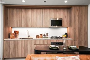 Chicago apartment for rent - A modern kitchen with wooden cabinets and a black countertop.