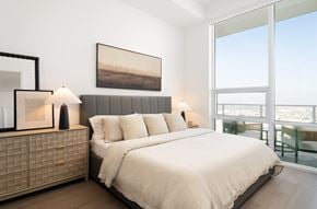 Los Angeles apartment for rent - A bedroom with a large bed and a painting on the wall.