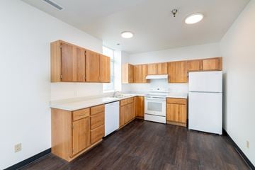 St. Paul townhouse for rent - an empty kitchen with white appliances and wooden cabinets