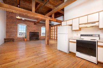 Saint Paul apartment for rent - a kitchen with a stove and a refrigerator in a room with wood floors