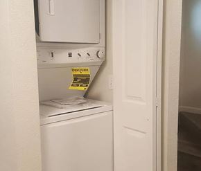 Bremerton apartment for rent - A yellow energy consumption label is on the back of a white dishwasher.