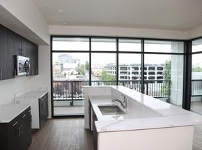 Bremerton apartment for rent - A modern kitchen with a large window overlooking the city.