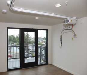 Bremerton apartment for rent - A room with a balcony and a fan on the wall.