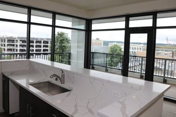 Bremerton apartment for rent - A kitchen with a marble countertop and a stainless steel sink.