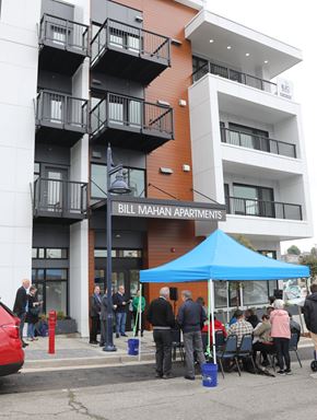 Bremerton apartment for rent - A group of people are standing outside of Bill Mahan Apartments.