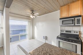 Bremerton apartment for rent - A kitchen with a stove, microwave, and oven.