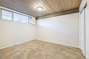Bremerton apartment for rent - A room with a wooden ceiling and carpeted floor.