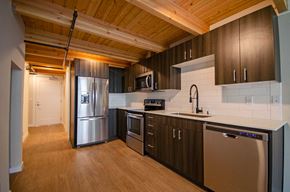 Bremerton apartment for rent - A kitchen with wooden cabinets and stainless steel appliances at B Flats Apartments, Washington 98337
