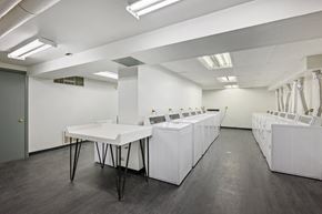 Chicago apartment for rent - a large room with white tables and sinks in it