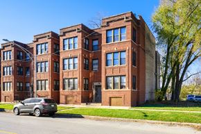 Chicago apartment for rent - a large brick building with a car parked in front of it