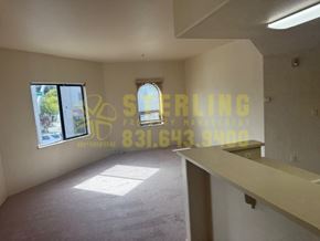 Monterey apartment for rent - A room with a carpeted floor and a window with blinds.