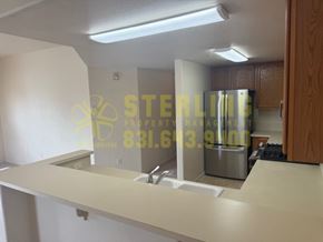 Monterey apartment for rent - A kitchen with a counter and a fridge.