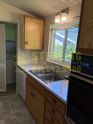 Monterey triplex for rent - A kitchen with a washing machine and a dishwasher.
