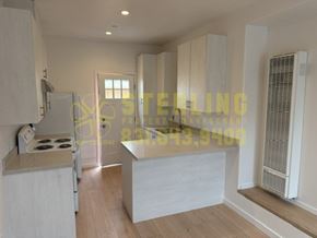 Marina townhouse for rent - A kitchen with a stove, cabinets, and a countertop.