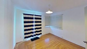 Monterey apartment for rent - a living room with a window and a curtain