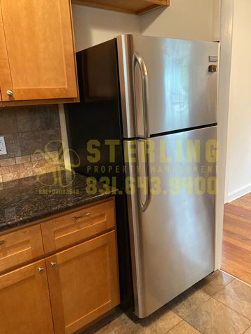 Pacific Grove triplex for rent - A stainless steel refrigerator in a kitchen.