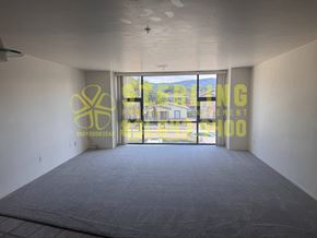 Monterey apartment for rent - A room with a carpeted floor and a large window with a view of the outside.